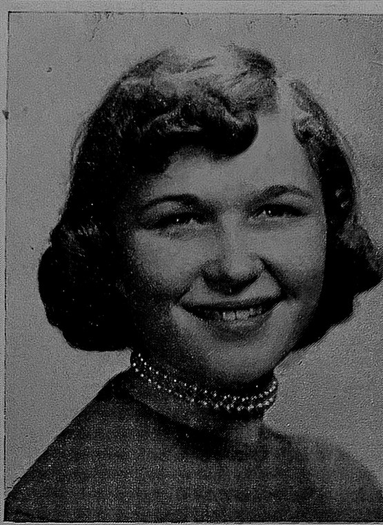 A yearbook portrait of a smiling teenage girl with short waved hair and a beaded choker, printed as a halftone.