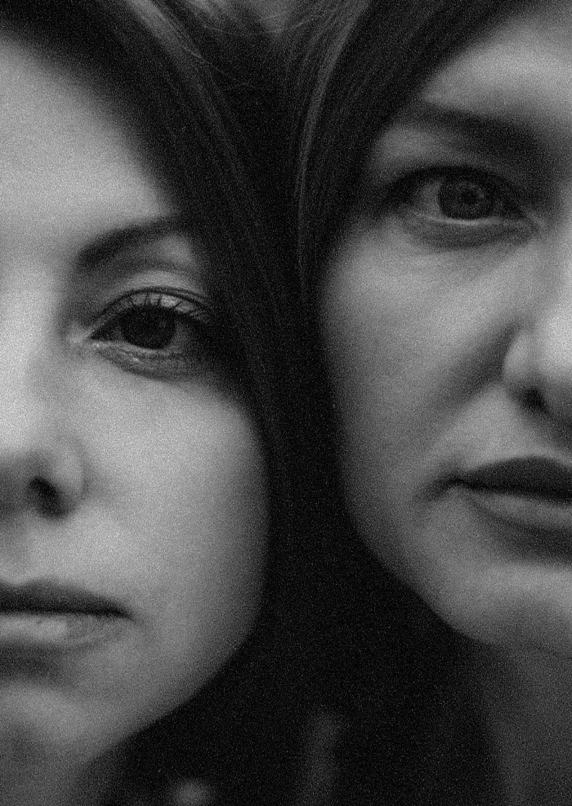 Two women, faces close together, black and white portrait