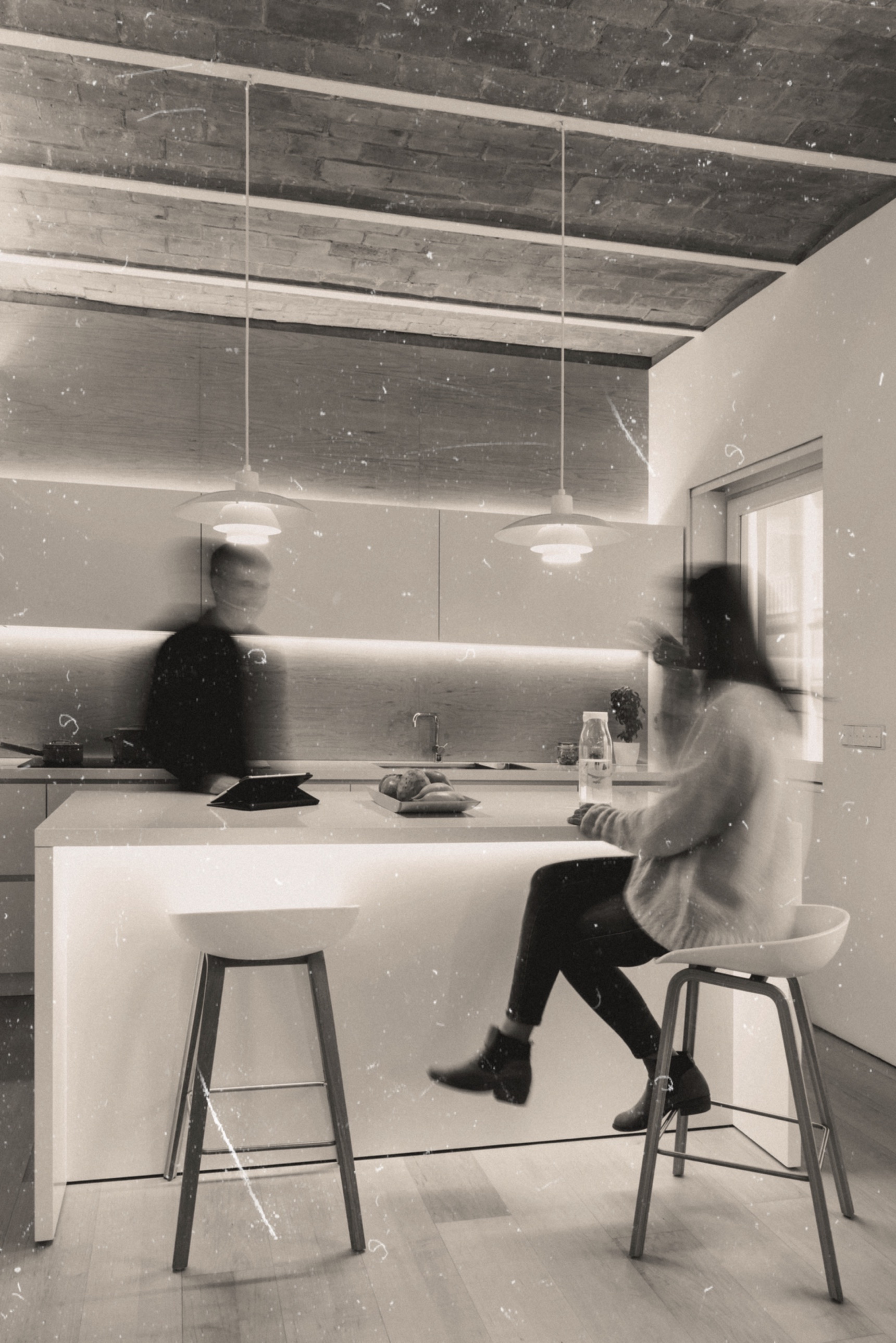 A couple in motion in their kitchen